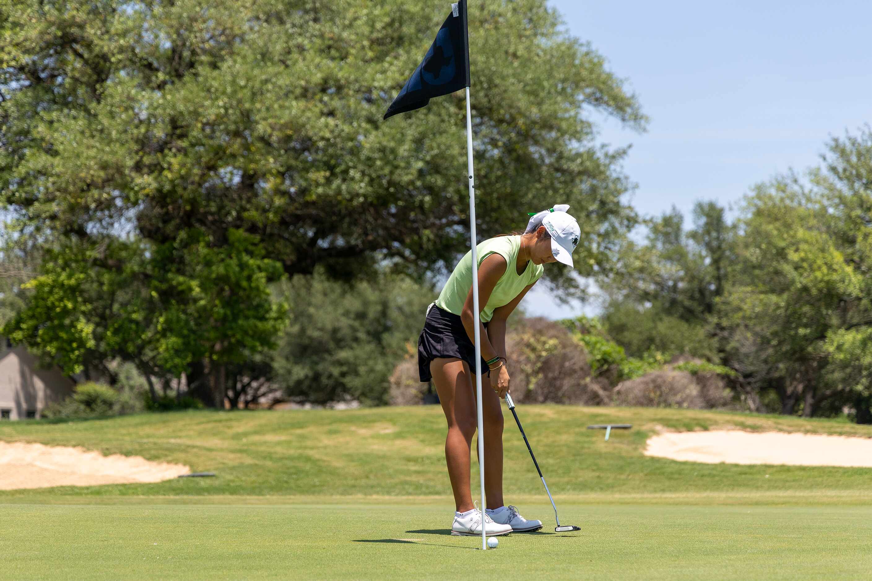 Southlake Carroll’s Ashley Kim putts for a birdie on the 18th green during the 6A girls...