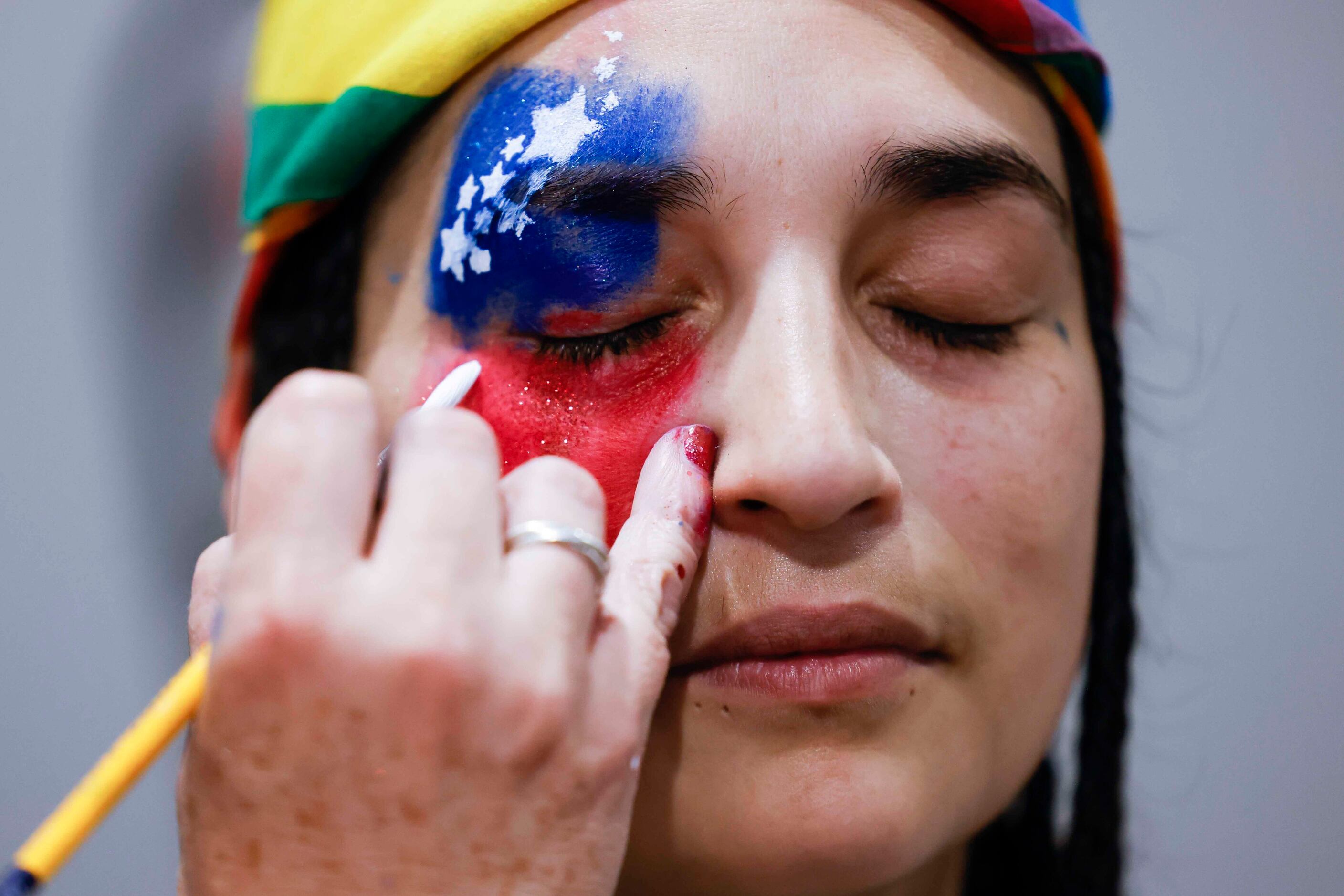 Max Longoria gets a face paint of U.S National flag during an Independence Day celebration...