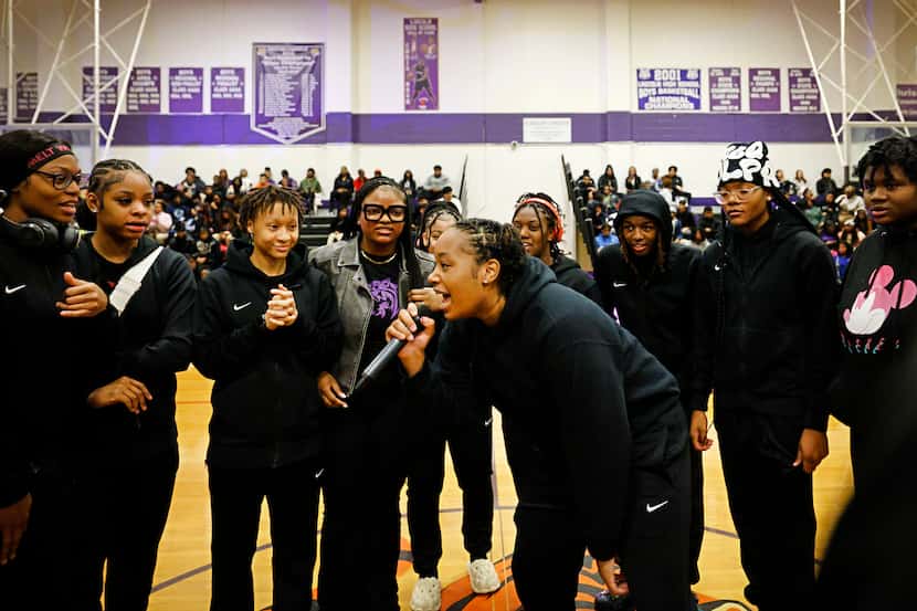Lincoln High School basketball player T’Anna Saddler, center, and her teammates celebrate...