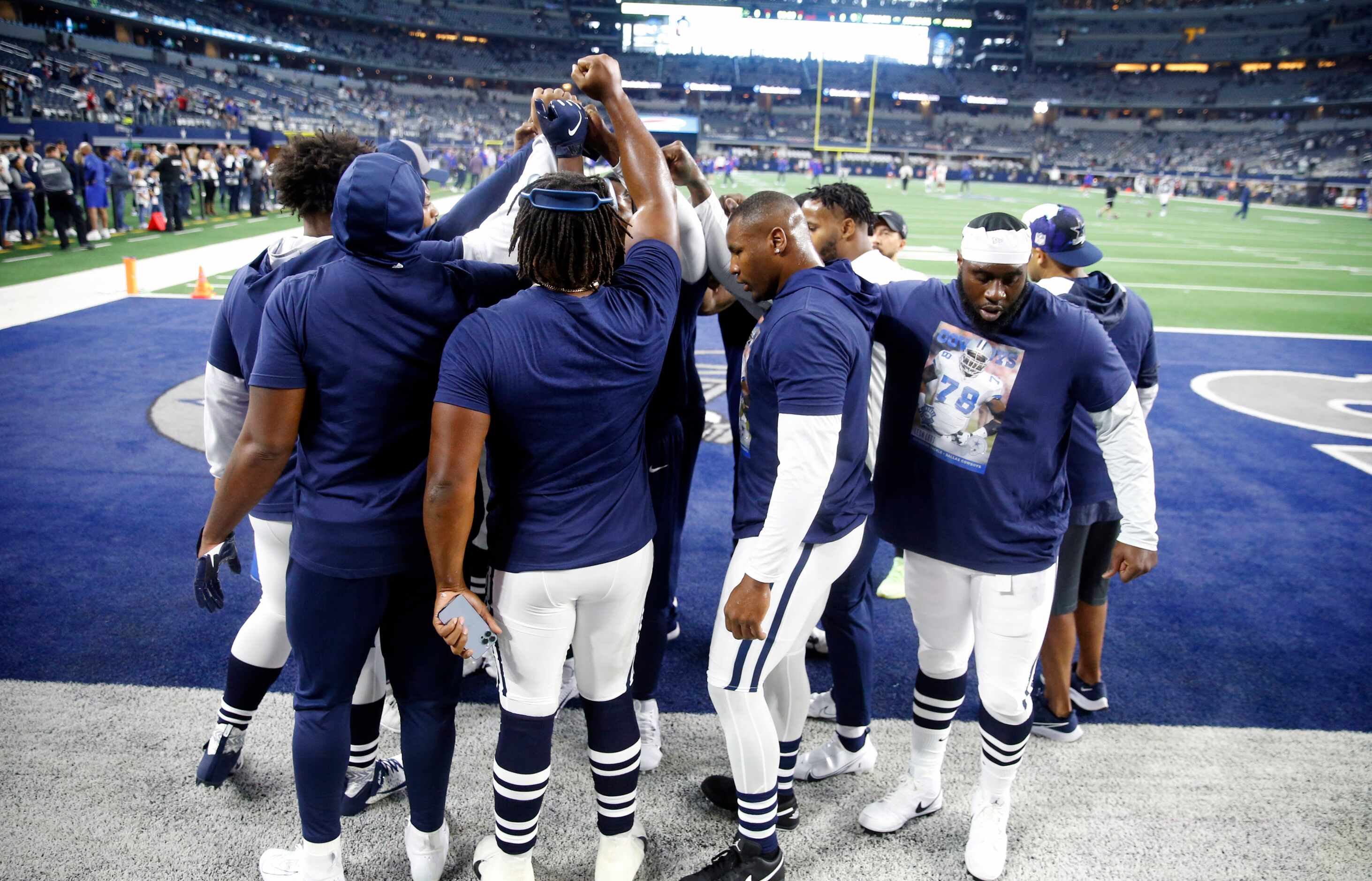 The Dallas Cowboys defensive lineman huddle during pregame warmups before the New York...