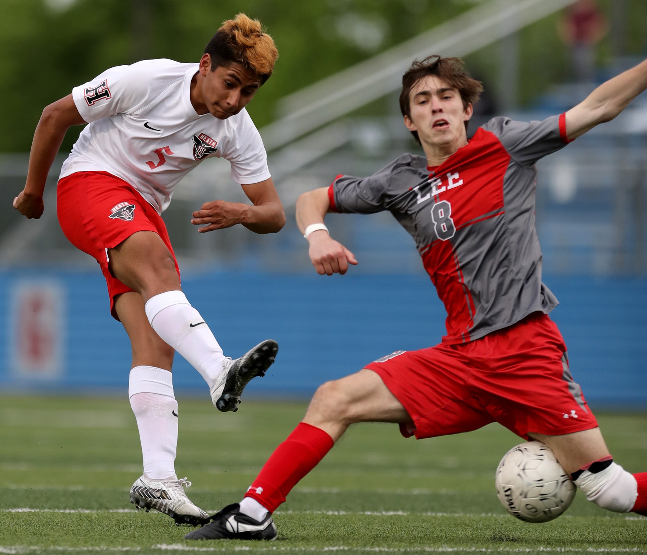 Rockwall-Heath's Chris Rodriguez (5) and SA Lee's Gavin Seesholtz (8) struggle for control...