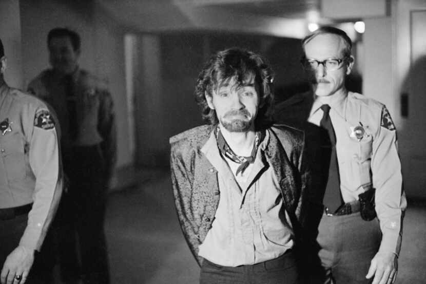 Charles Manson reacts to photographers as he goes to lunch after an outbreak in court that...