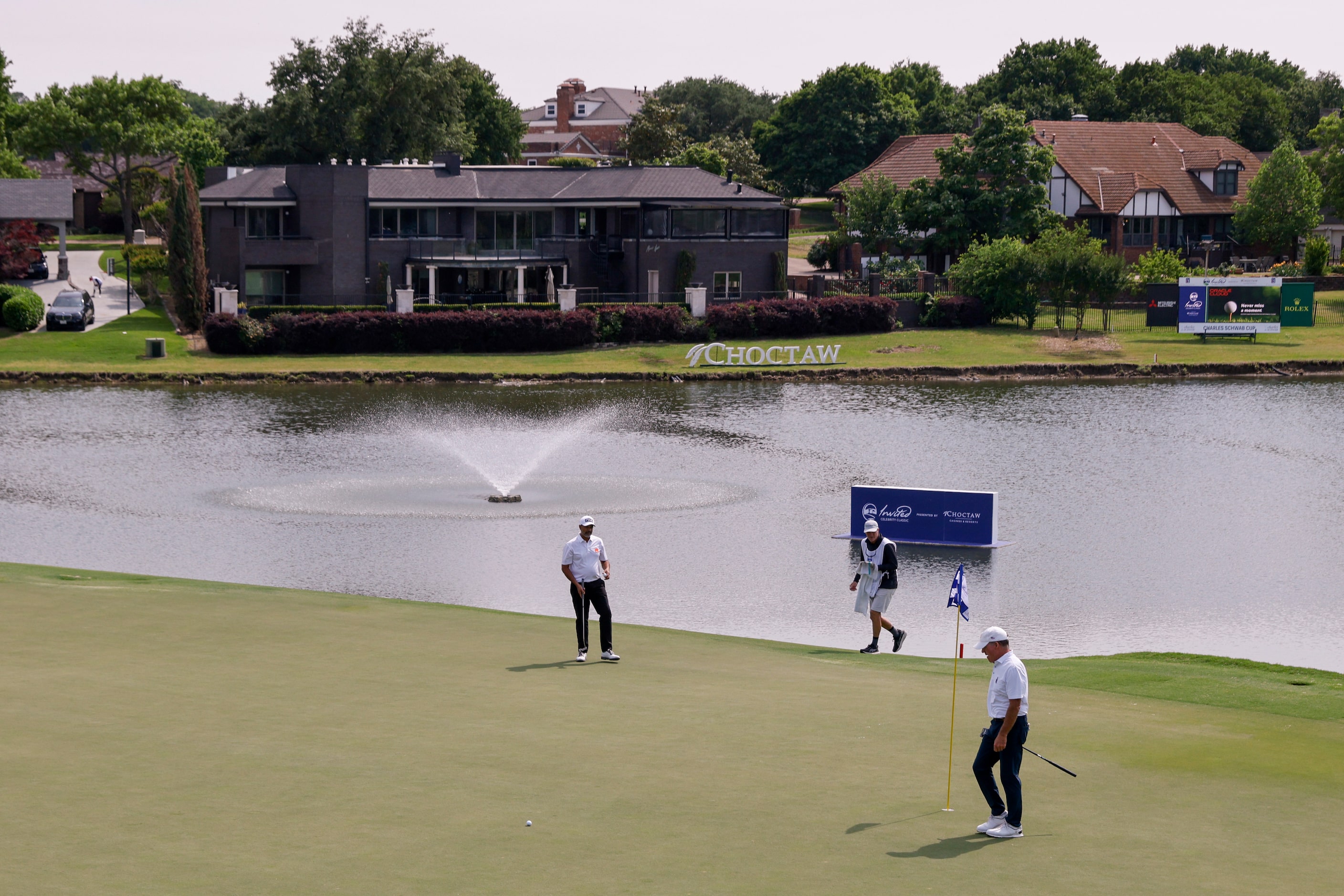 Professional golfers Arjun Atwal (left) and Fran Quinn walk the 18th green before playing...