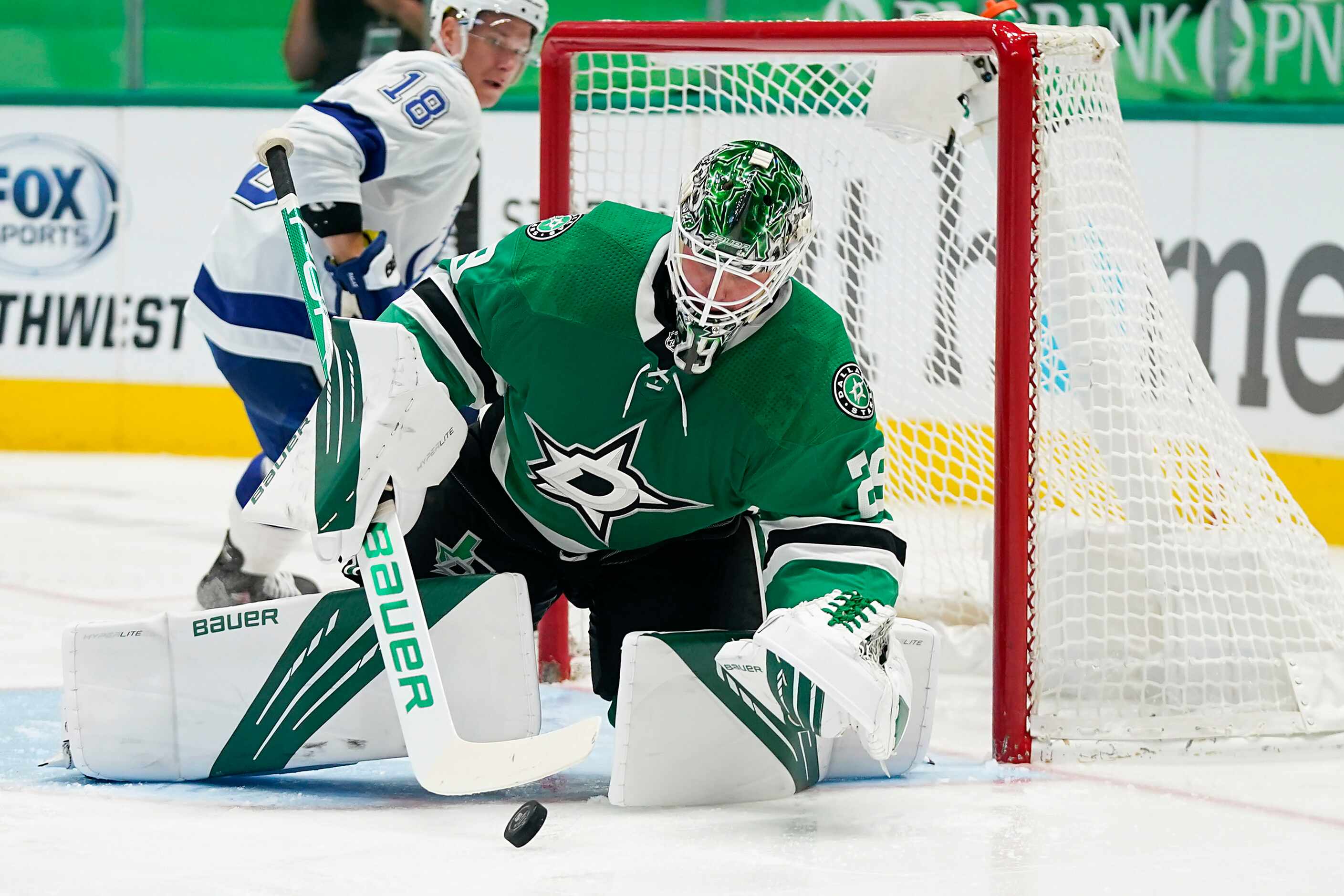 Dallas Stars goaltender Jake Oettinger covers up the puck in front of Tampa Bay Lightning...