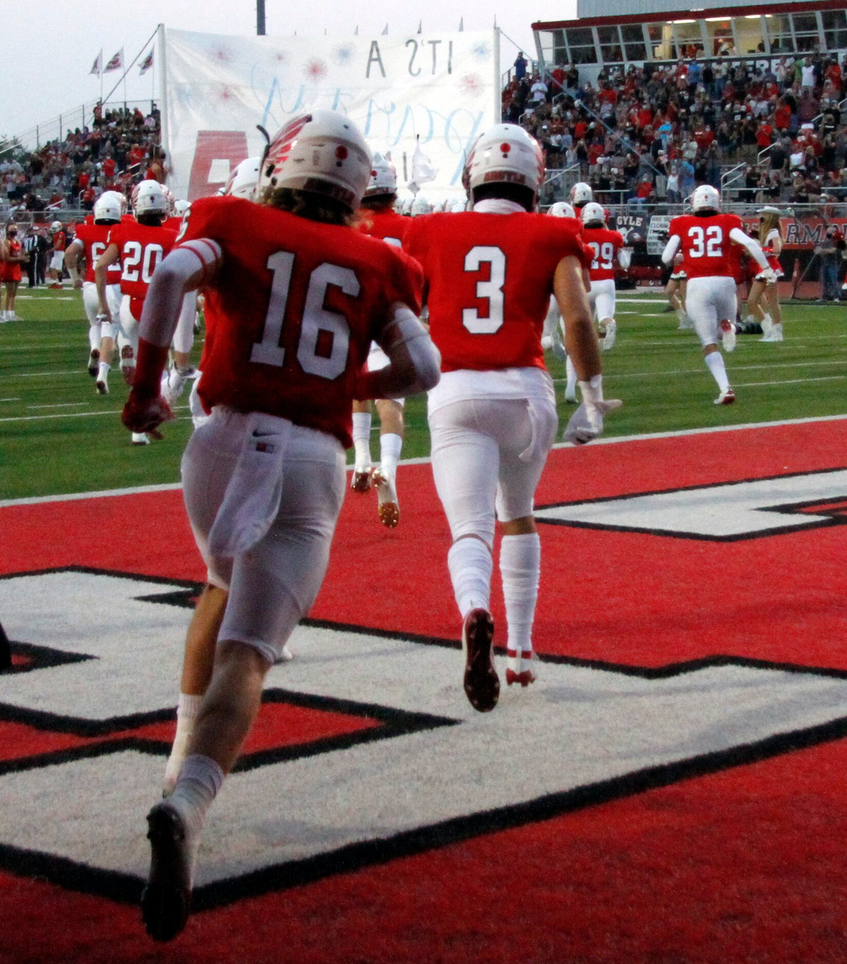 Members of the Argyle Eagles rush onto the field just prior to the opening kickoff of their...