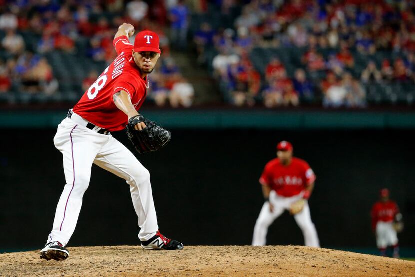 Texas Rangers relief pitcher Alex Claudio (58) pitches in the ninth inning against the...