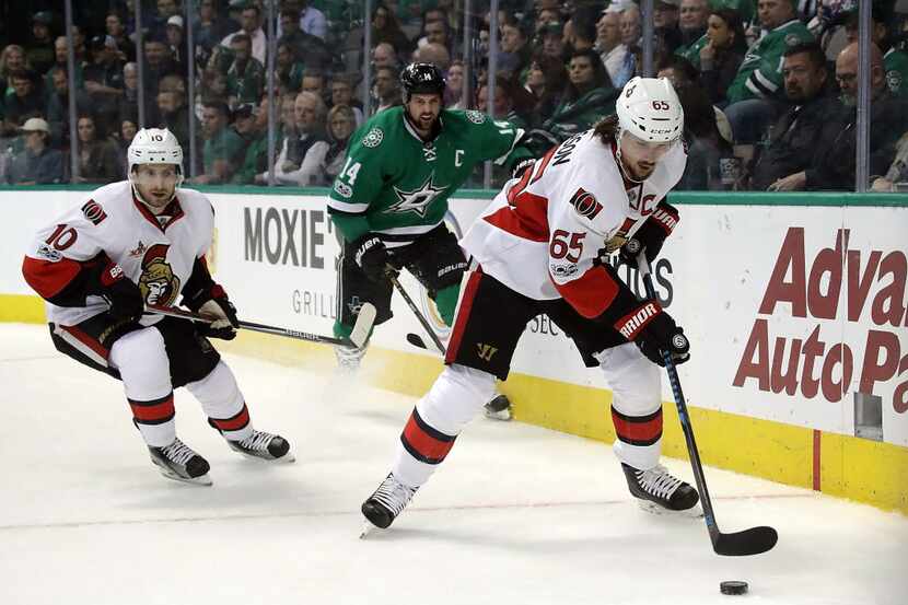 DALLAS, TX - MARCH 08:  Erik Karlsson #65 of the Ottawa Senators skates the puck against the...
