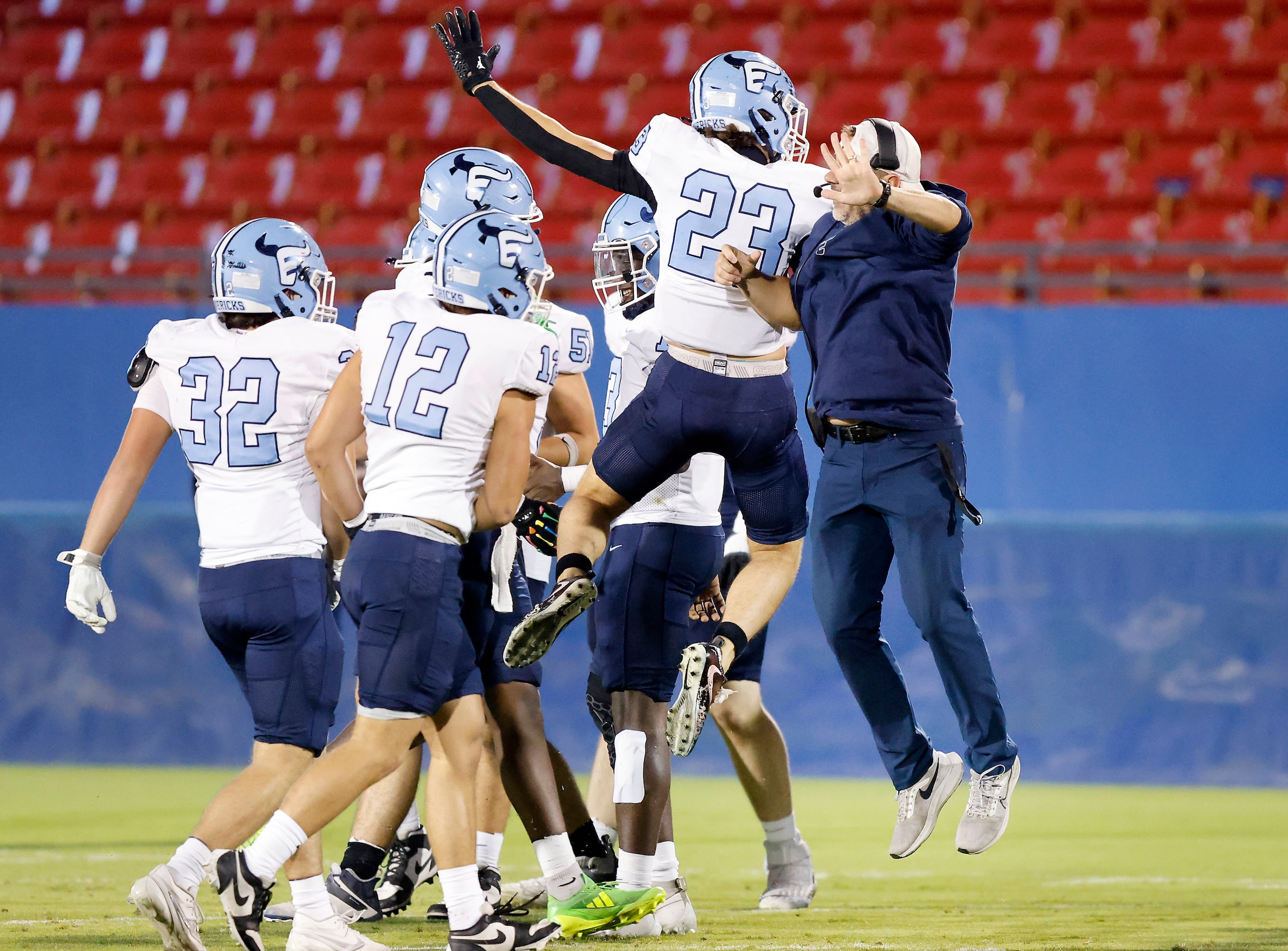 Frisco Emerson linebacker Nate Leal (23) celebrates a first half interception with his coach...