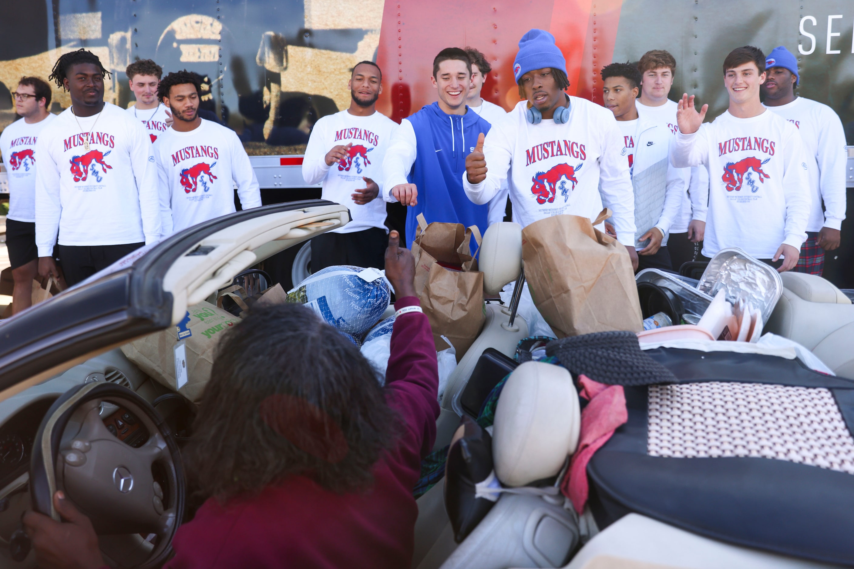 Pamela Booth reacts towards Southern Methodist University football players including Tarian...