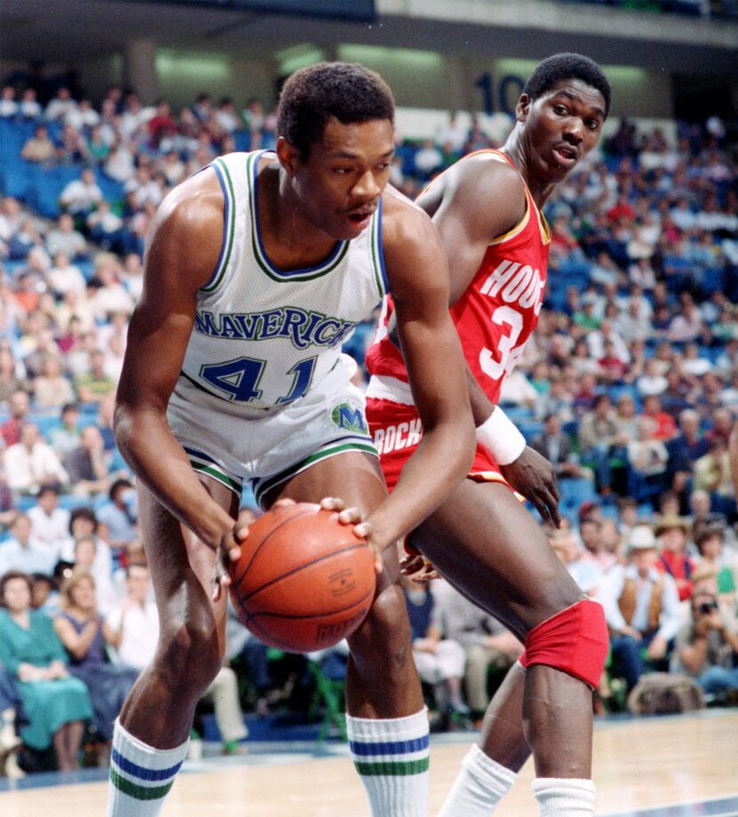 Dallas Mavericks' Sam Perkins and Houston Rockets' Akeem Olajuwon in action during the first...