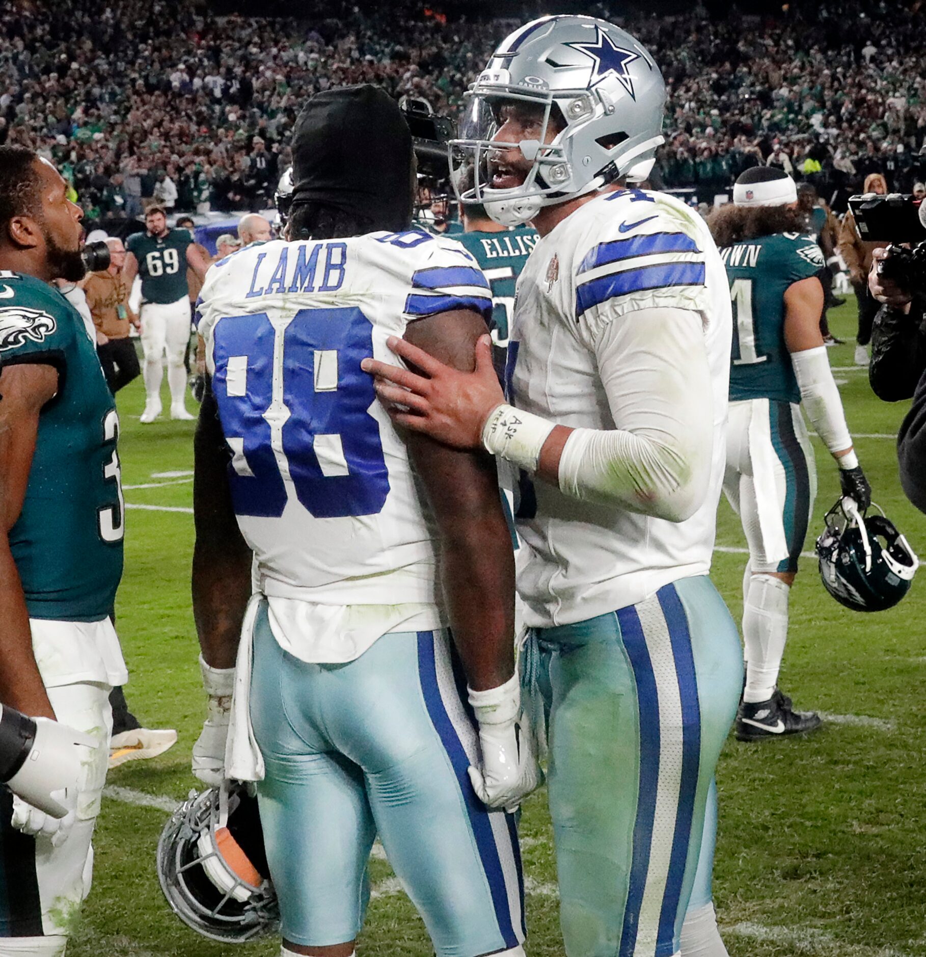 Dallas Cowboys quarterback Dak Prescott (4) consoles wide receiver CeeDee Lamb (88) after...