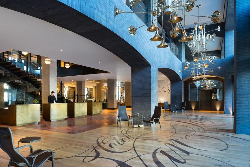 Hotel Van Zandt  in Austin’s Rainey Street area has a two-story lobby with music-inspired...