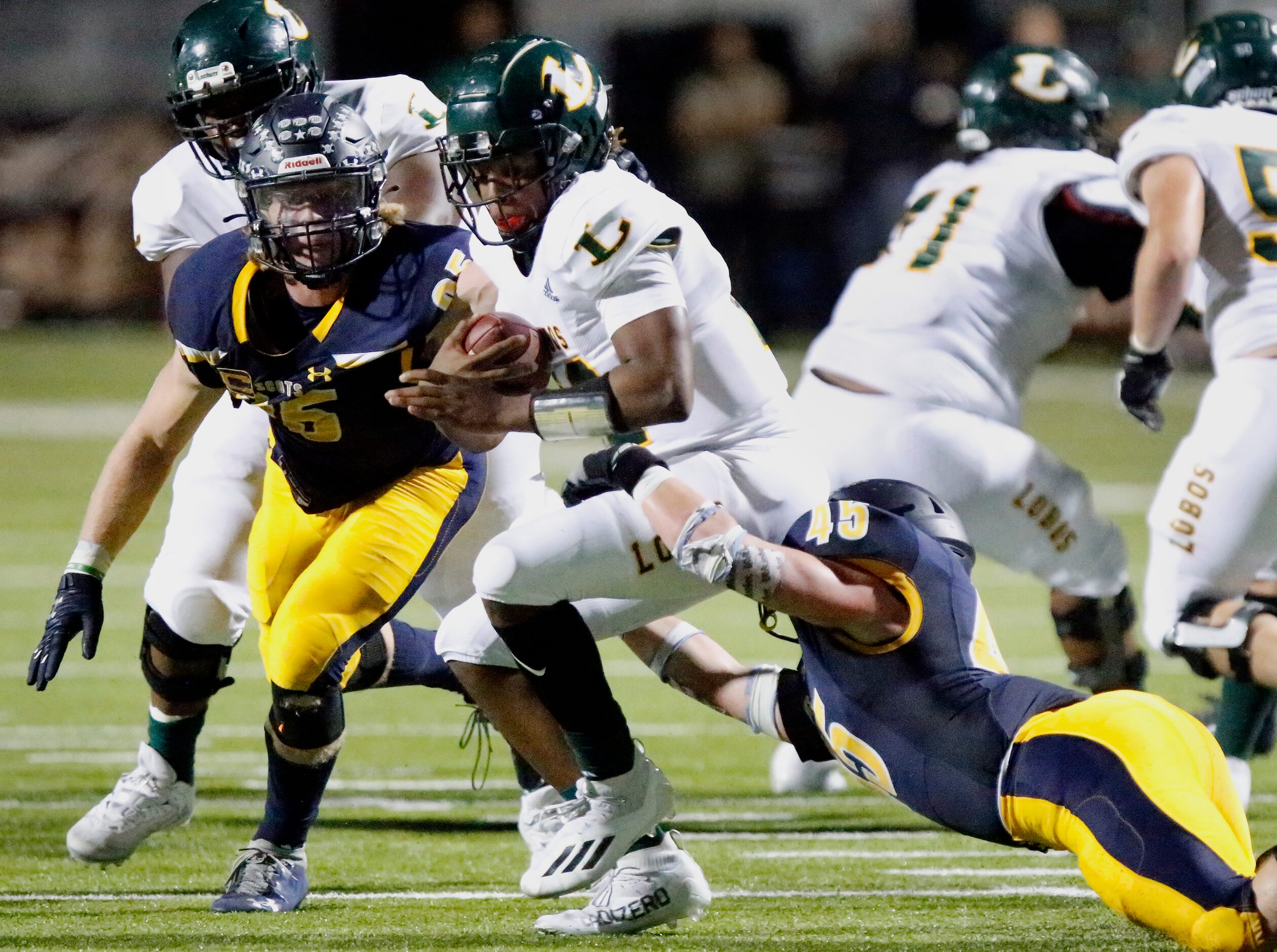 Longview High School quarterback Jordan Allen(12) is taken down by Highland Park High School...