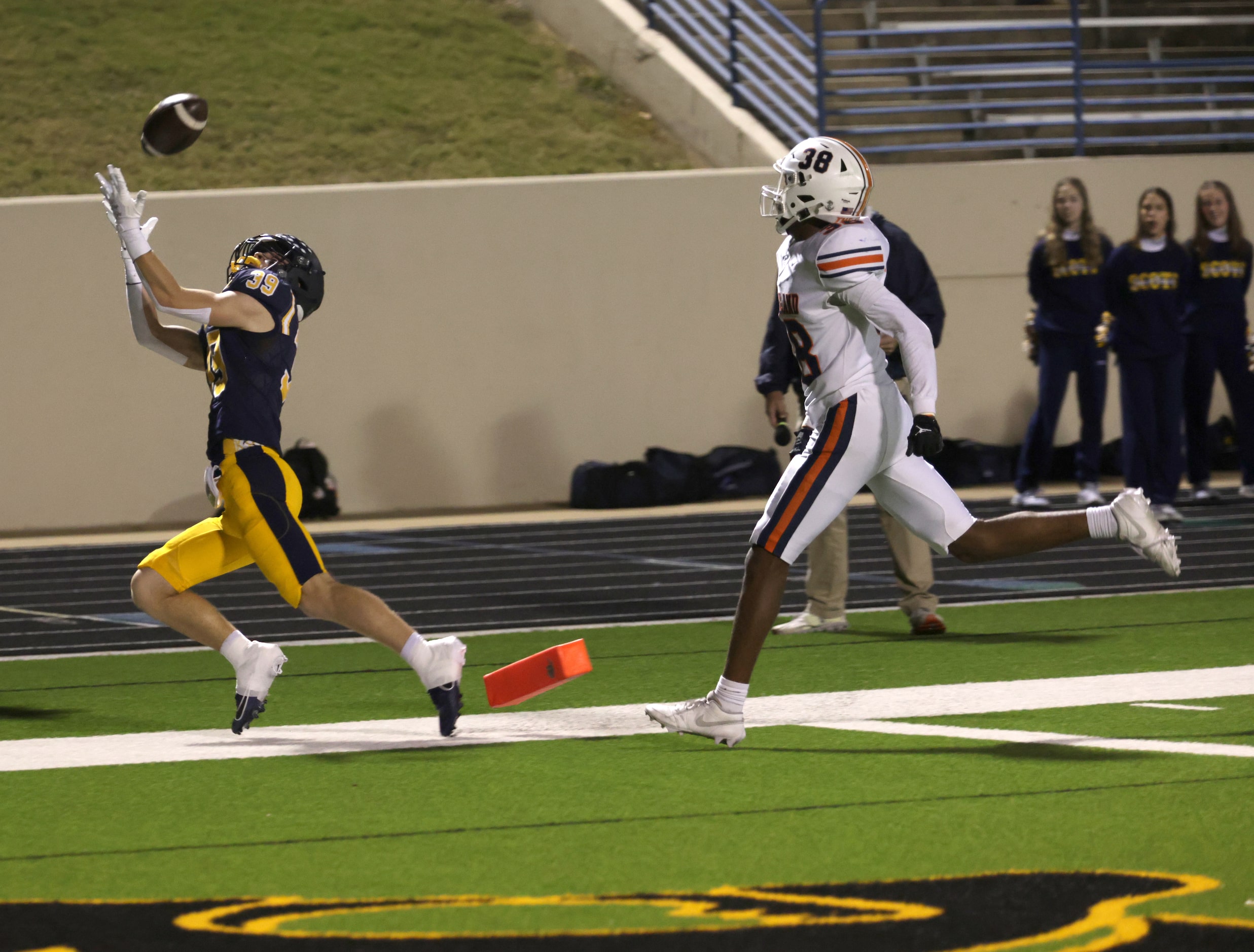 Highland Park's Harrison Cullum falls out of bounds before grabbing a pass in a football...