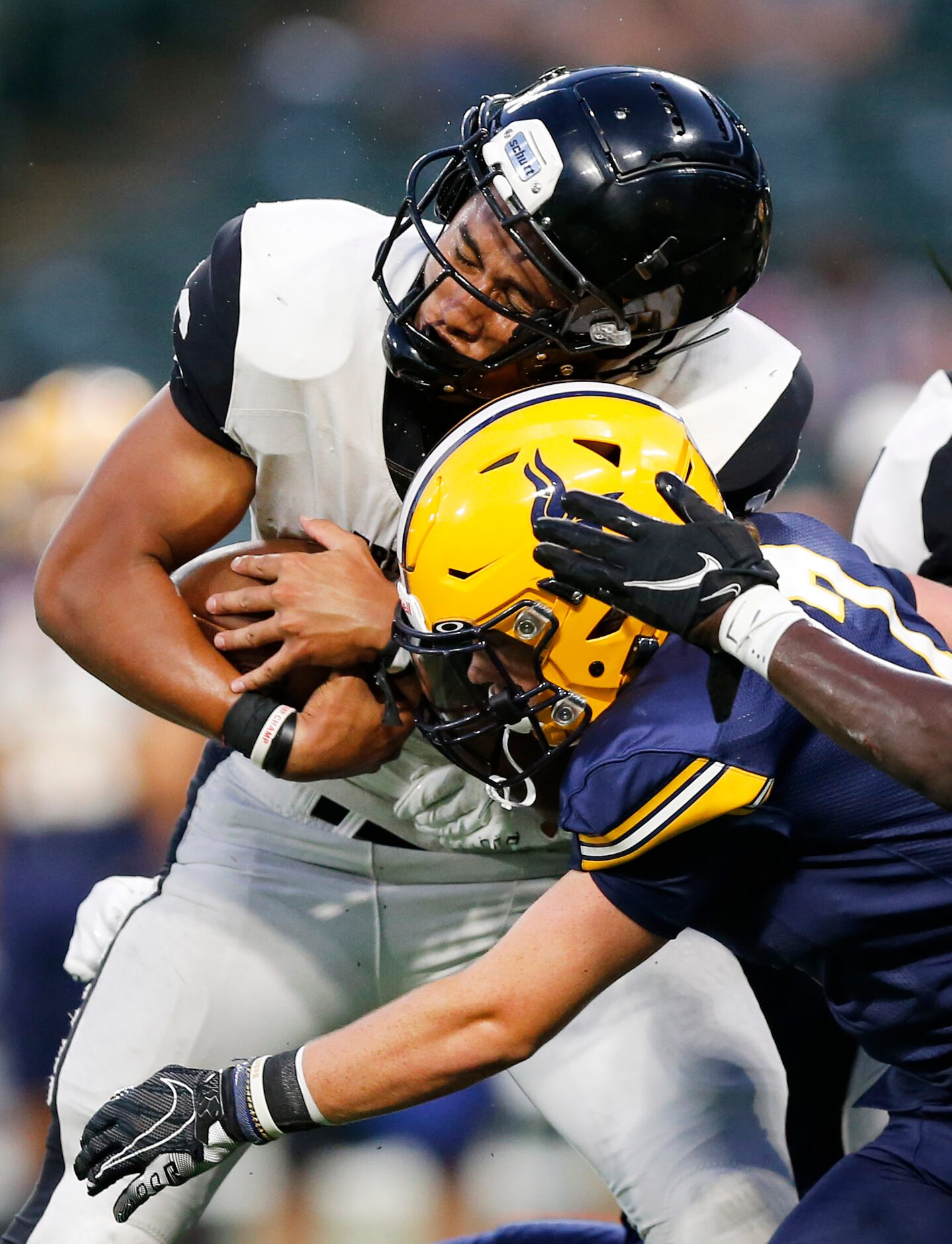 Arlington Lamar defensive back Harrison Griffith (7) puts a hit on Euless Trinity running...