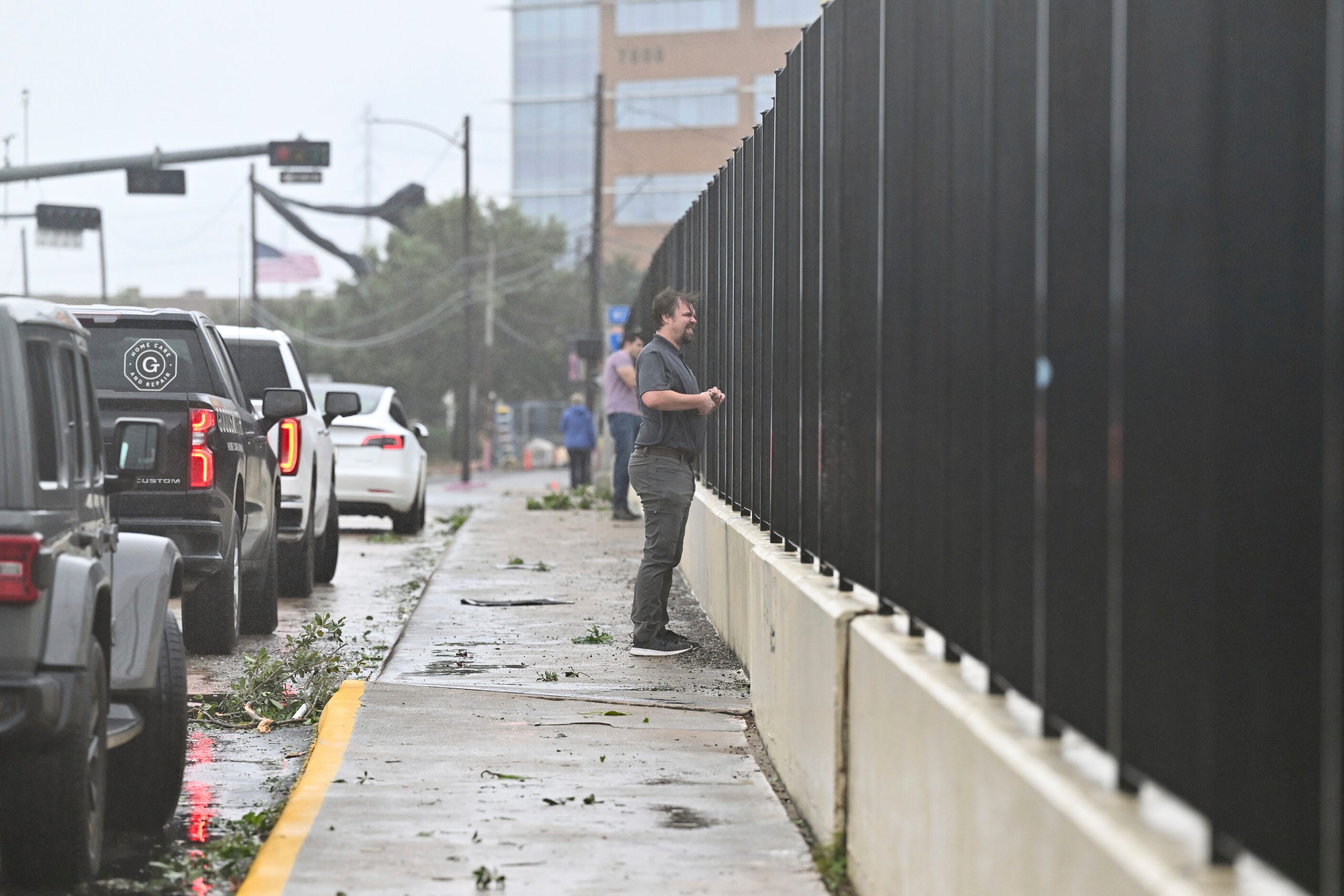 On lookers take photos of high waters on a flooded highway in Houston, on Monday, July 8,...