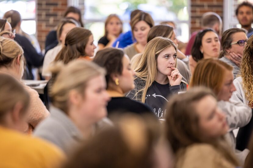 Preservice teachers listen closely at an ethics seminar provided by the Athens State college...