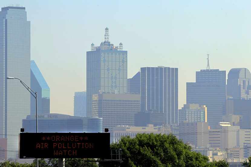 A highway sign alerts drivers on Interstate 35E to air pollution conditions in Dallas. Level...