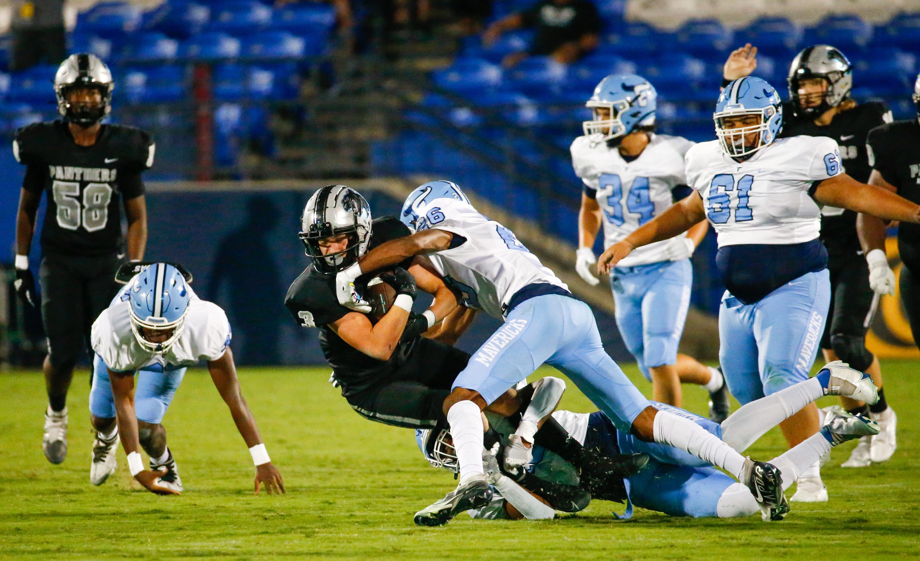 Emerson Mavericks defenders tackle Panther Creek Panthers wide receiver Seth Jackson (3)...