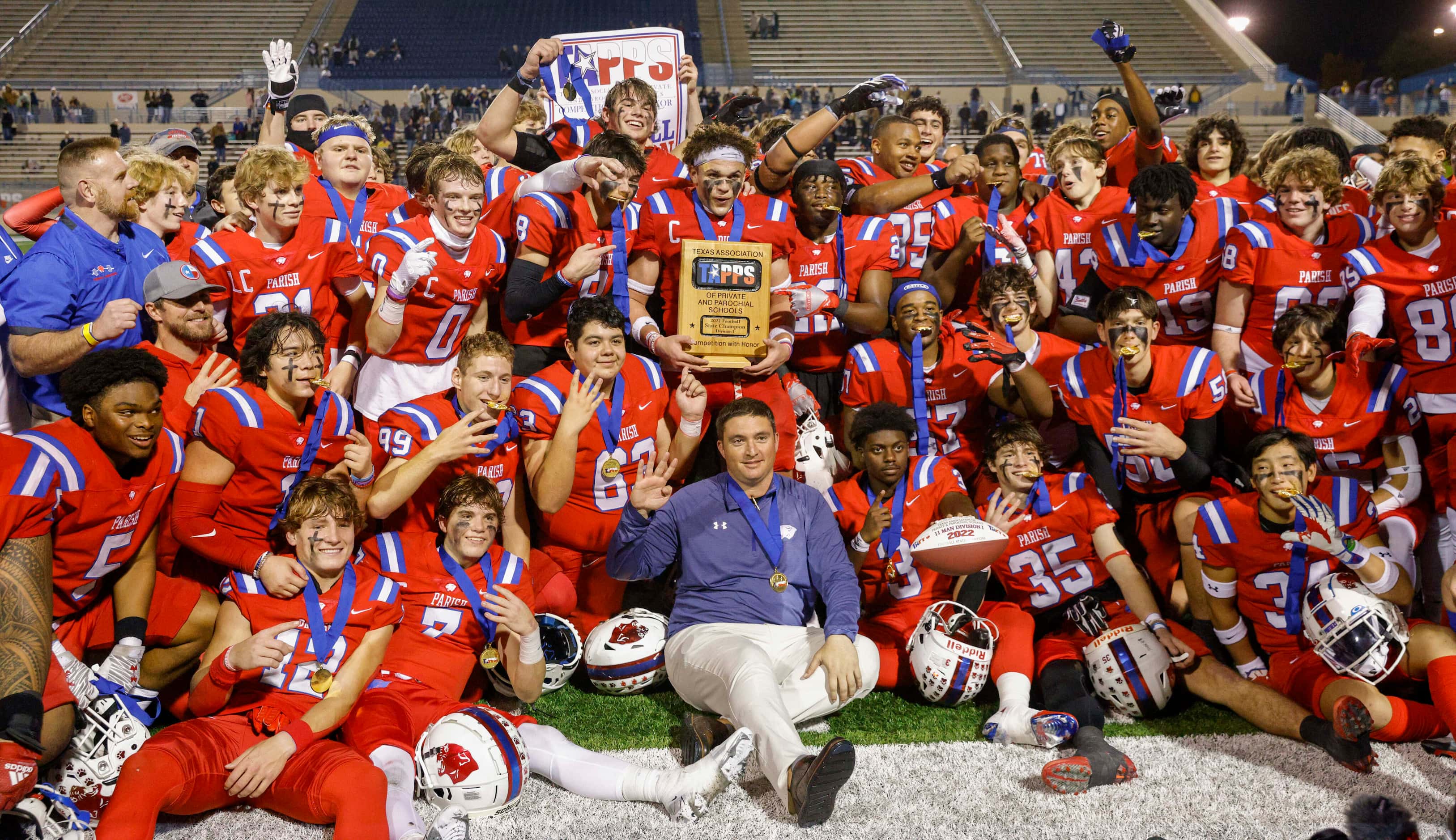 Parish Episcopal players and coaches pose for photos after winning the TAPPS Division I...