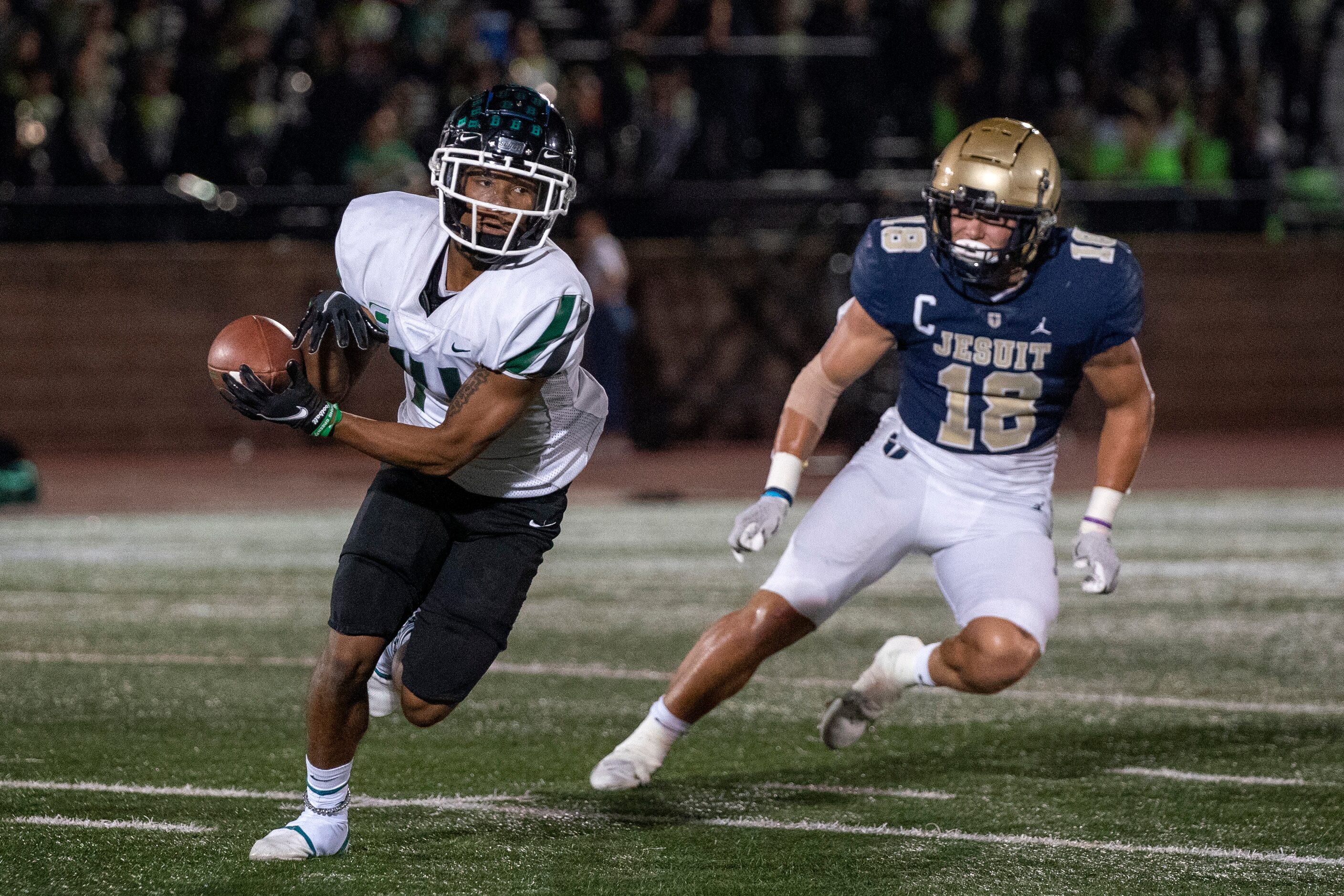 Richardson Berkner senior wide receiver Jamaal Saine (14) turns upfield against Jesuit...