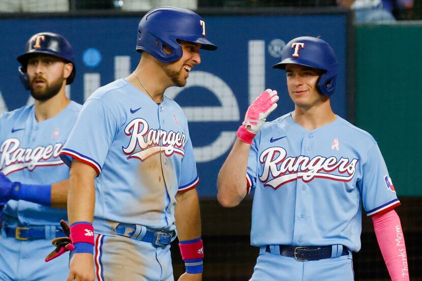 Texas Rangers second baseman Nick Solak (15) and Texas Rangers first baseman Nate Lowe (30)...