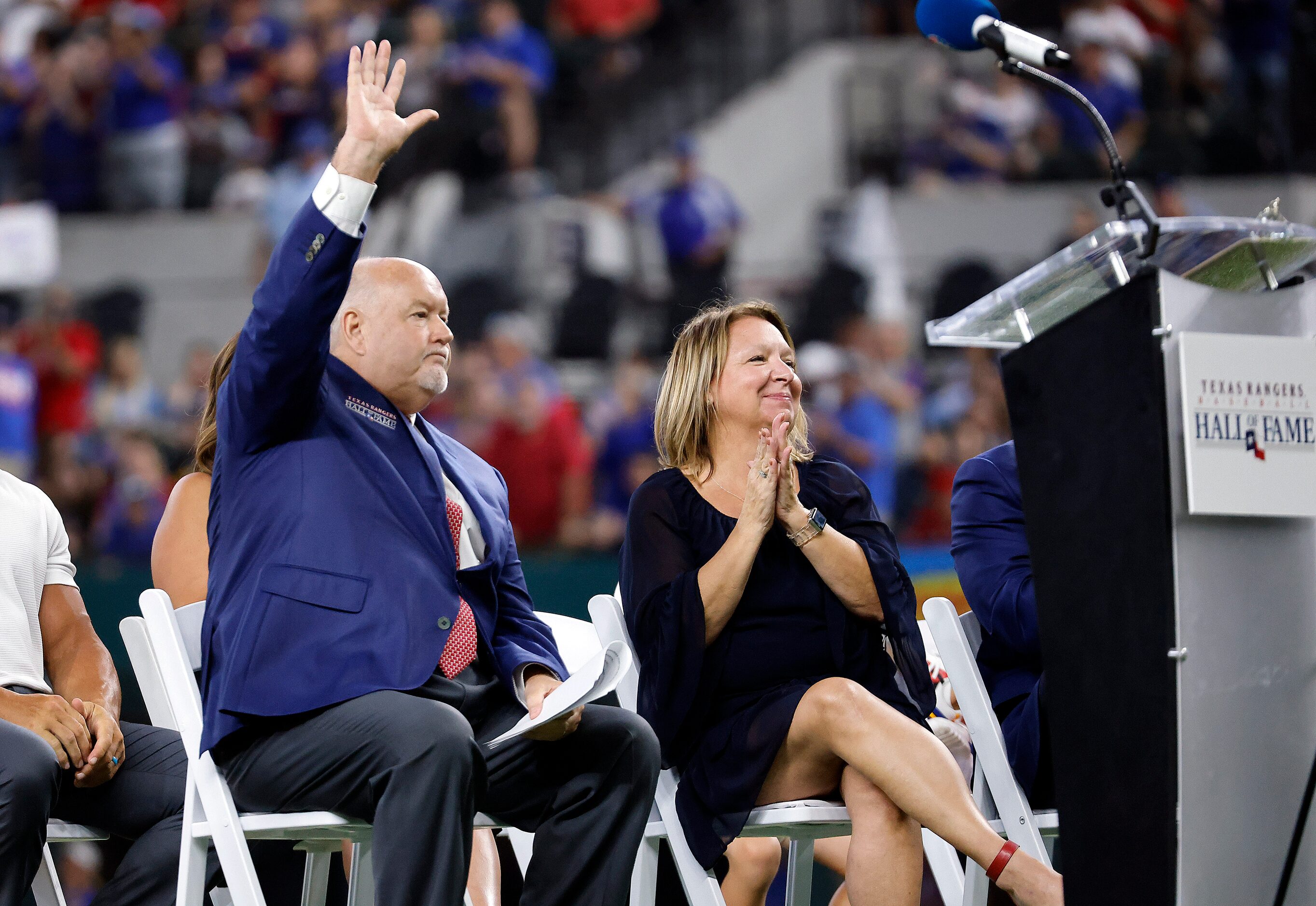 Texas Rangers executive vice president and public address announcer Chuck Morgan waves t the...