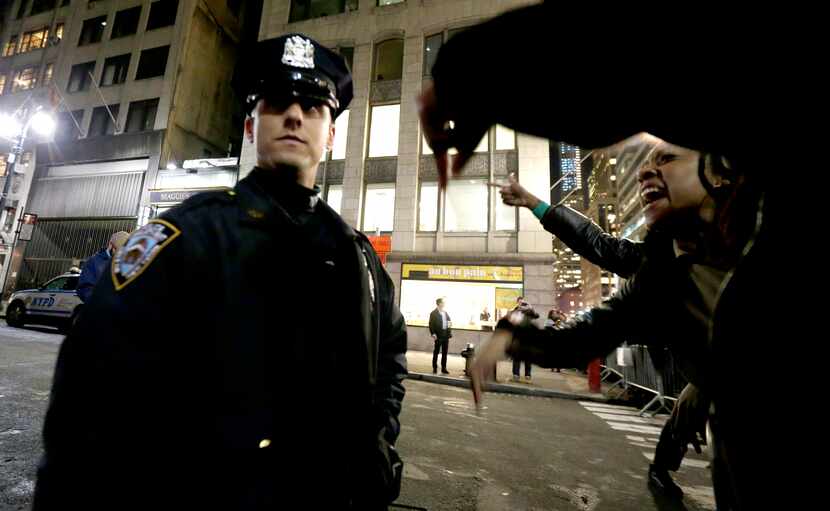 A woman yells at a New York City Police officer during a protest after it was announced that...