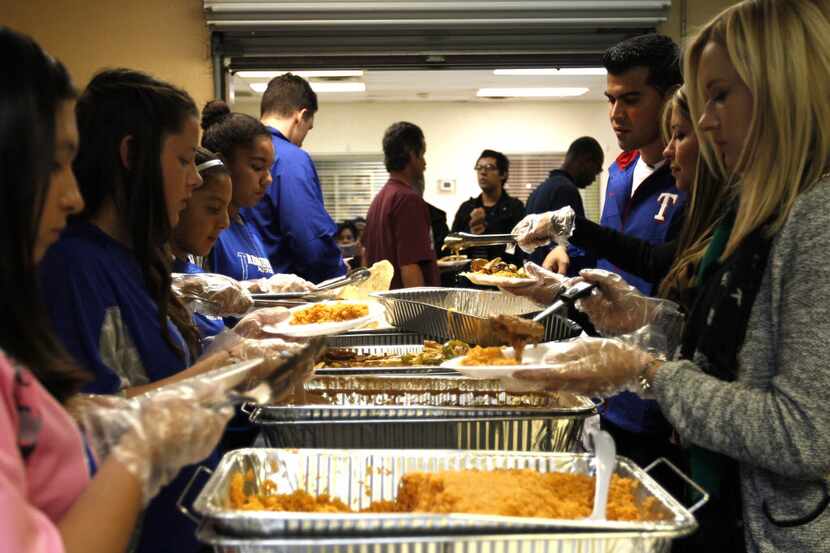 Arlington Life Shelter, shown during a Thanksgiving dinner, received $30,000 in the first...