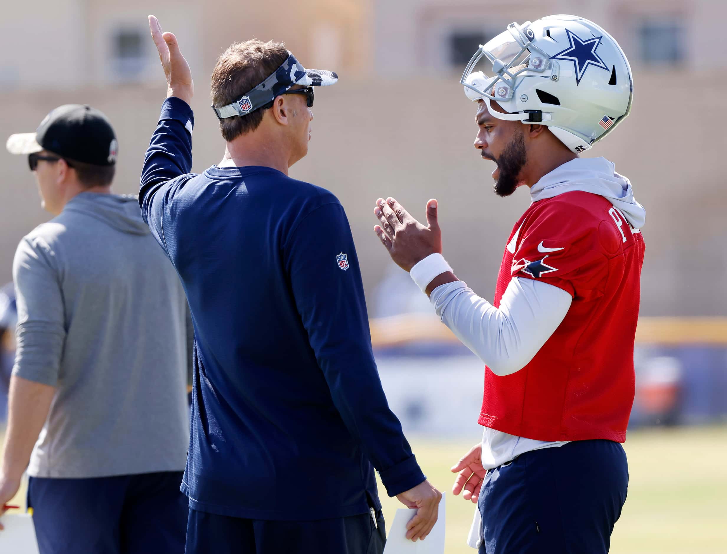 Dallas Cowboys quarterback Dak Prescott (right) converses its quarterbacks coach Doug...