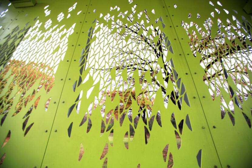 The leafy screen pattern was cut by water jet into the steel sidewalls of the new pavilion...