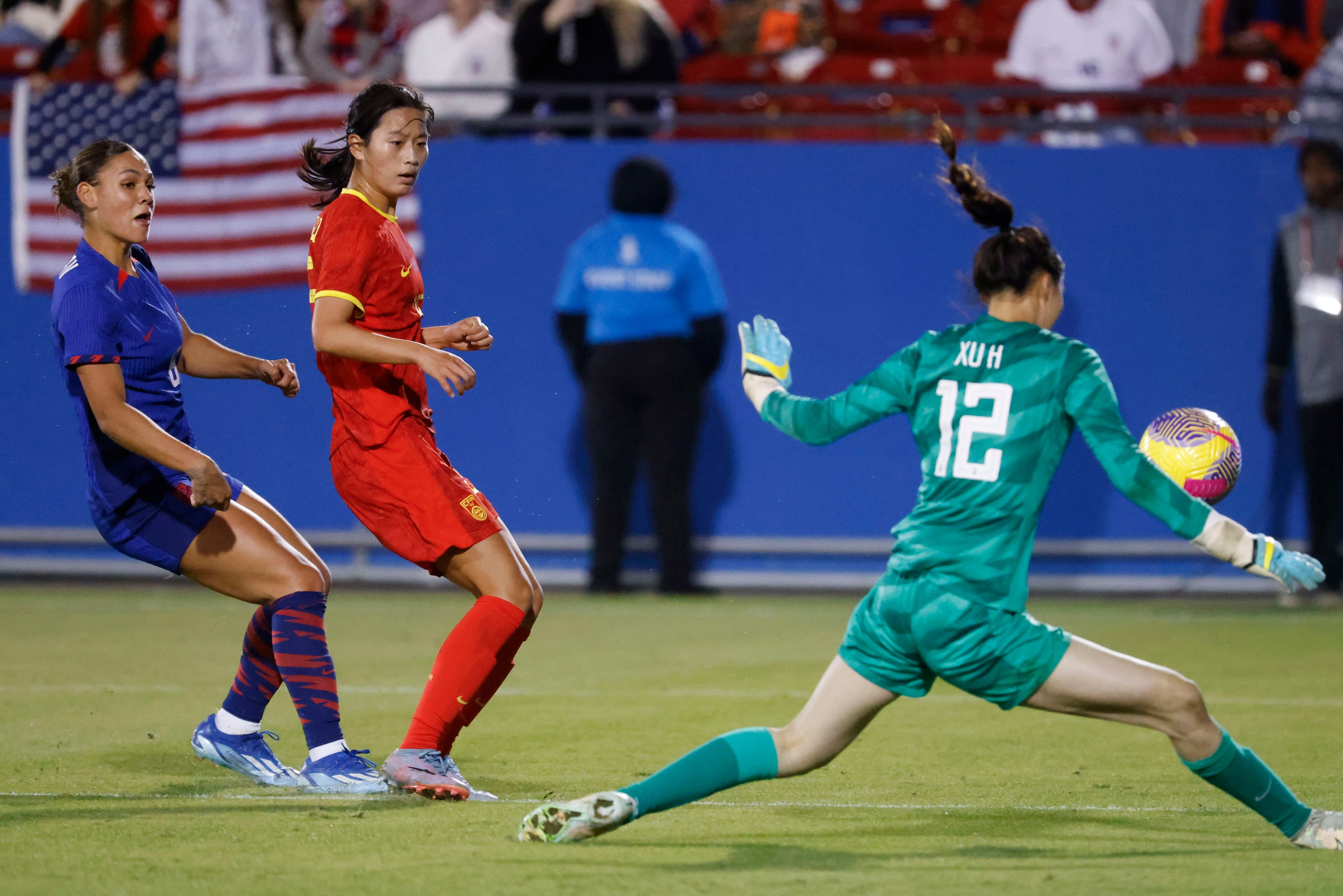 China’s goal keeper Xu Huan (right) saves a shot by United States’ Trinity Rodman (left)...