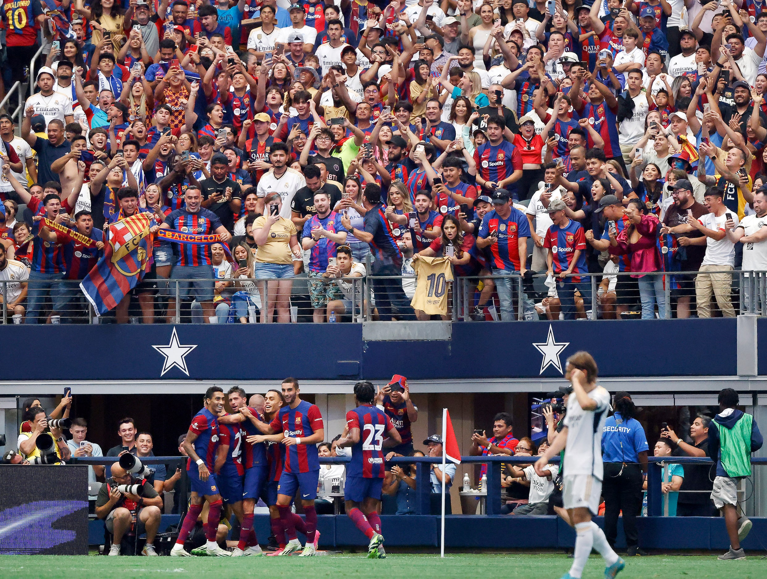 Barcelona fans celebrate Fermin Lopez’s second half goal against the Real Madrid in their...