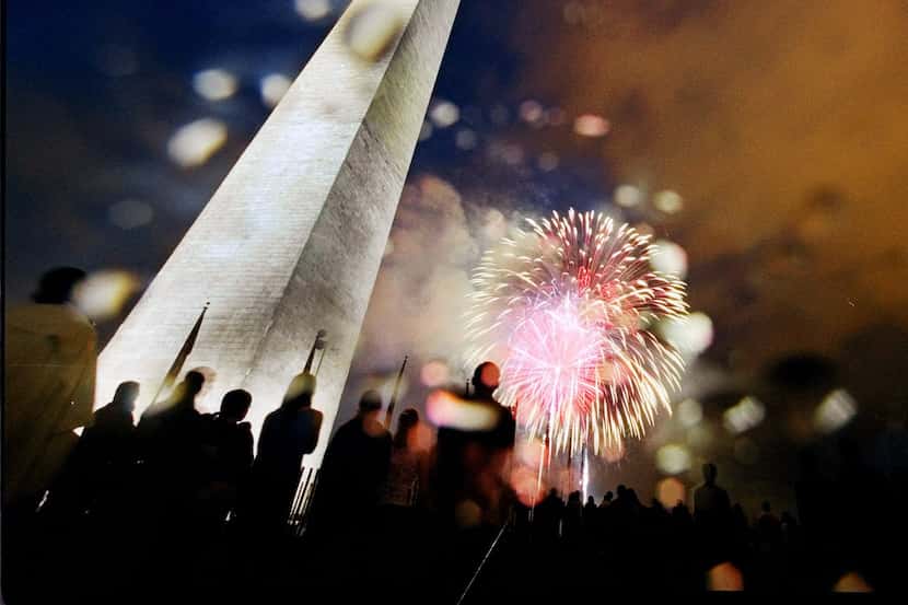 Fireworks exploded, despite the rain, near the Washington Monument during the celebration...