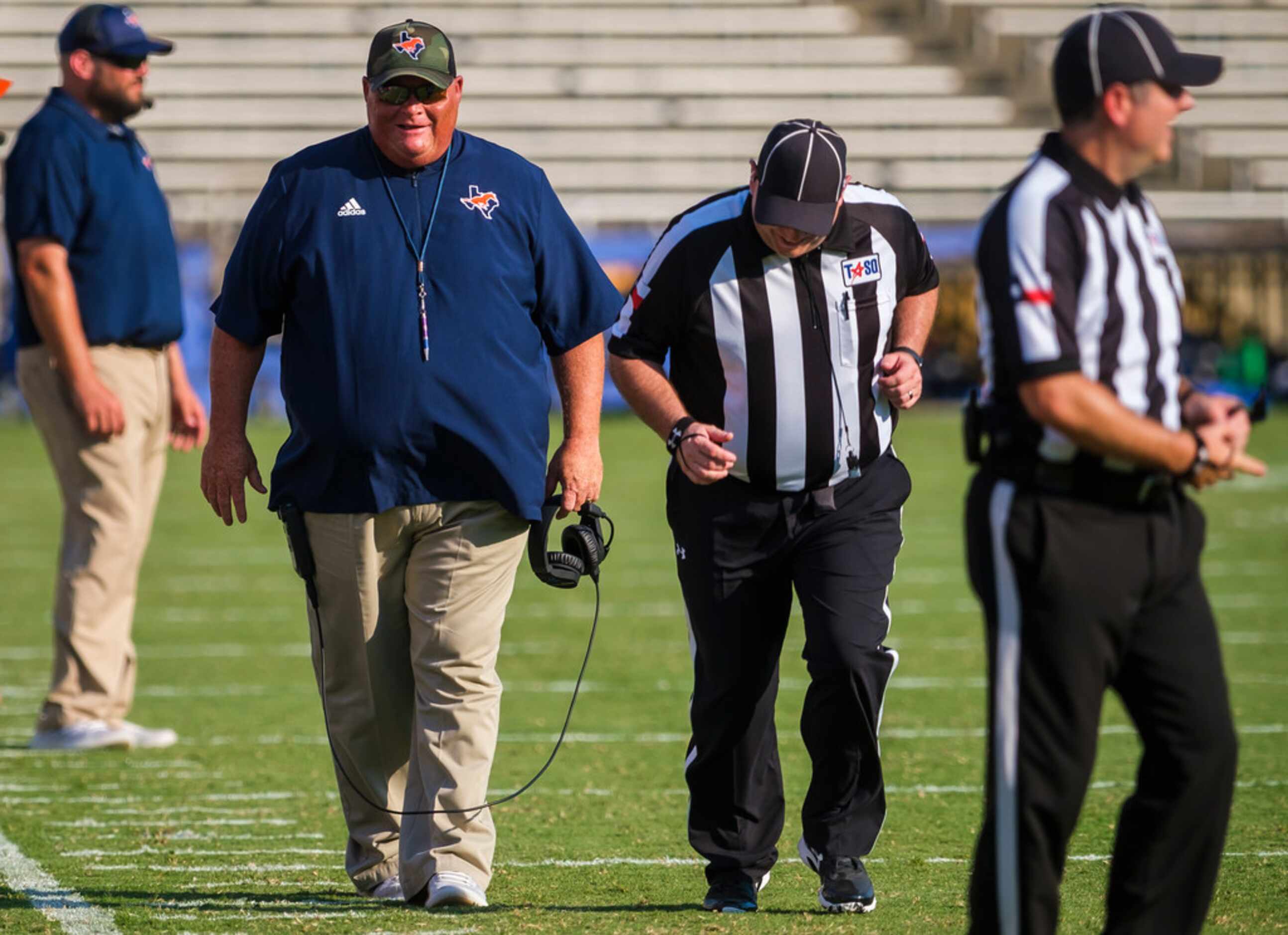 Sachse head coach Mark Behrens talks to an official during the first half of a high school...