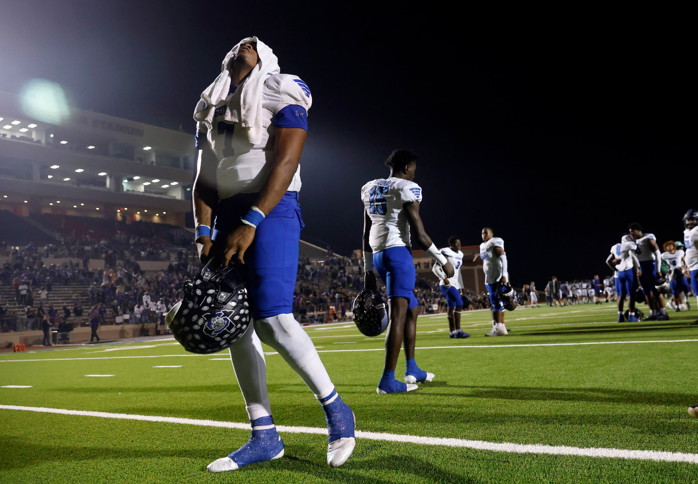 Mansfield Summit senior quarterback David Hopkins gathers himself after their loss to...