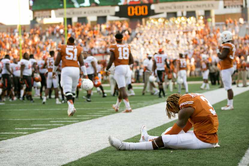 Texas wide receiver Armanti Foreman sits on the field after Oklahoma State's 30-27 win in an...