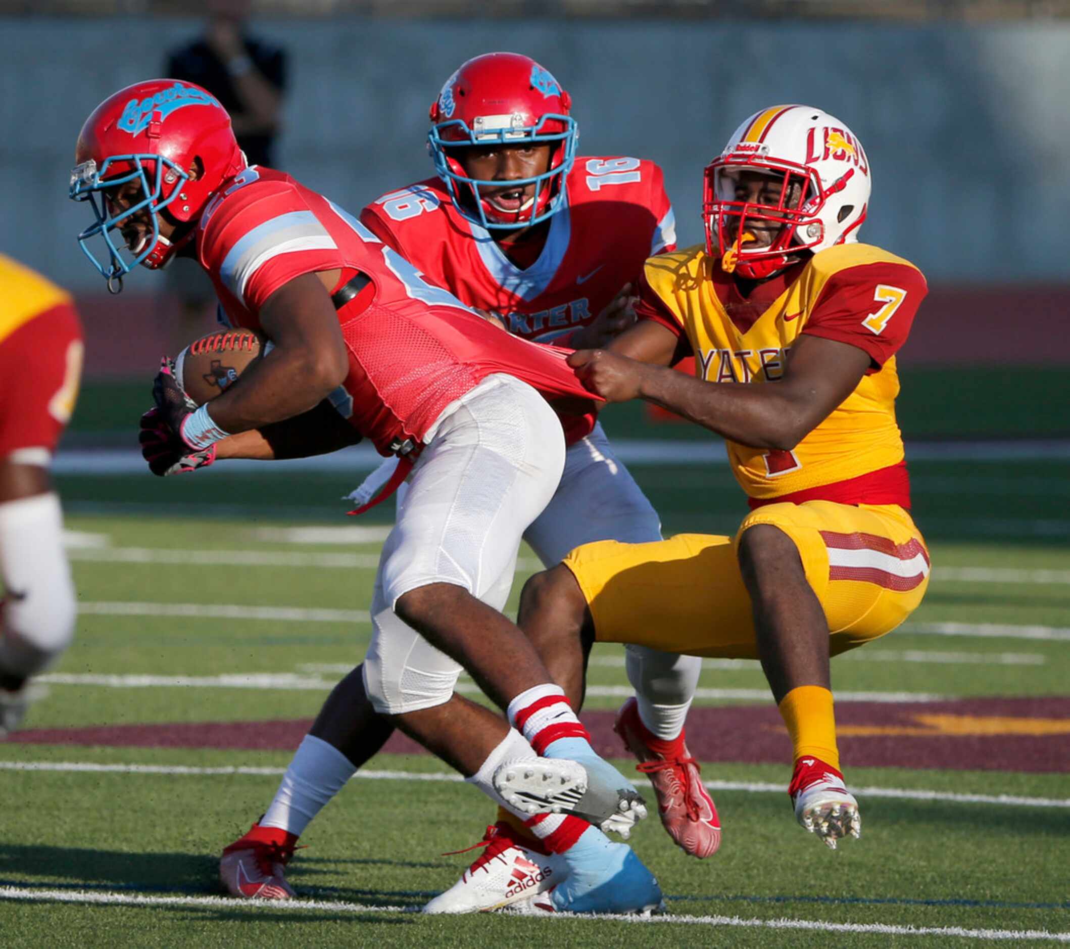 Dallas Carter running back Jamalrian Jones , left, gets tackled by Houston Yates defender...