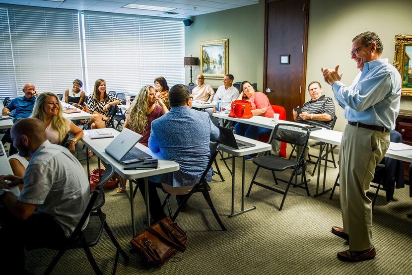 Vice president JR Russel welcomes new agents during a Fathom Realty orientation in Plano.