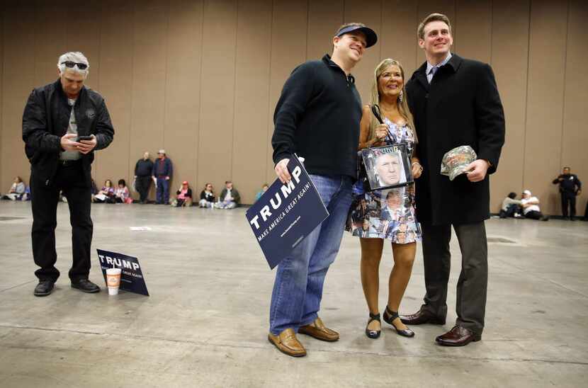 Barbara Tomasino of Plano posed for a photo in her Donald Trump dress with fellow supporters...