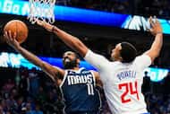 Dallas Mavericks guard Kyrie Irving (11) drives against LA Clippers guard Norman Powell (24)...