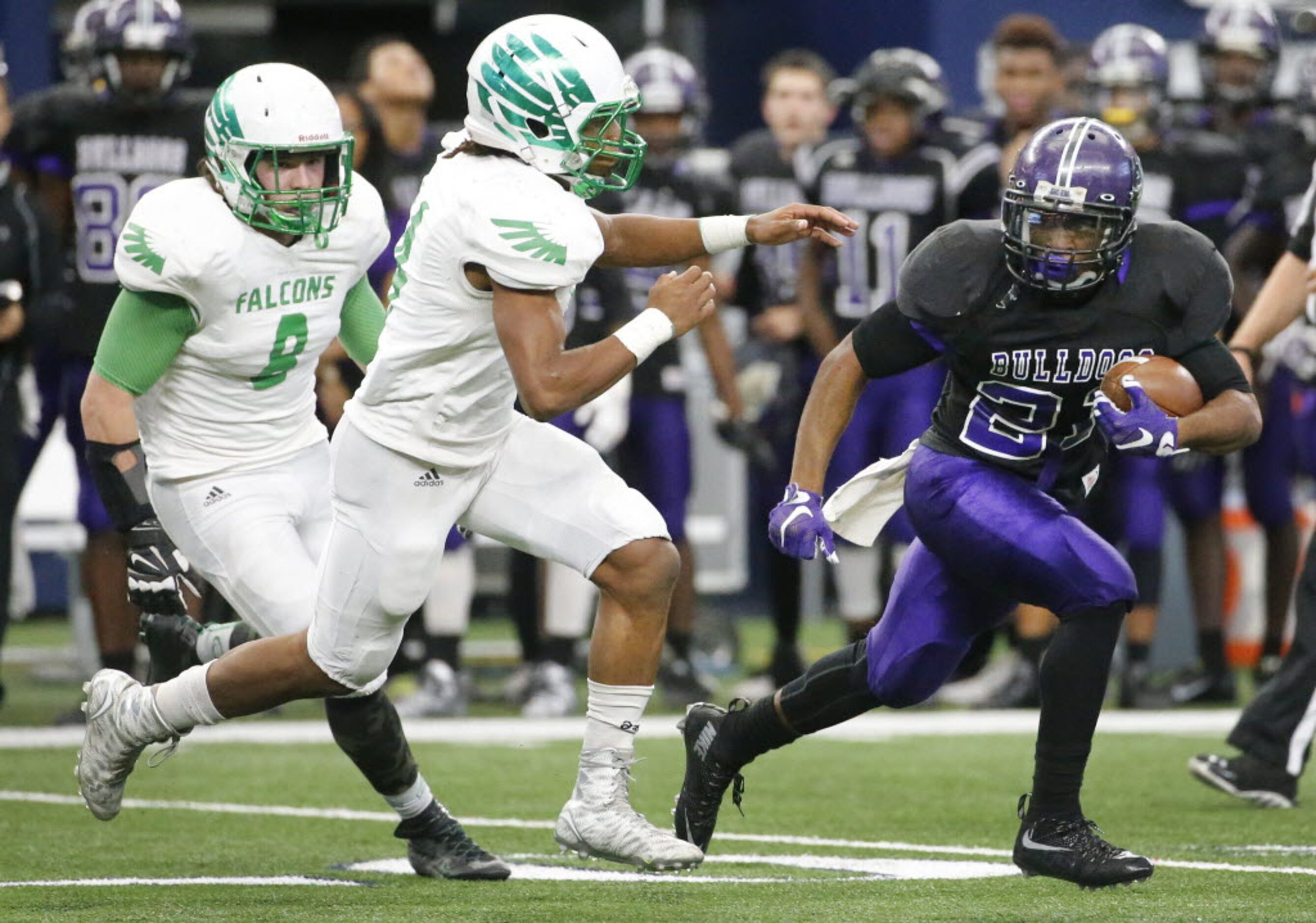 Everman's Kierre Crossley (21) is chased down by Lake Dallas defender Courtenay Holder (14)...