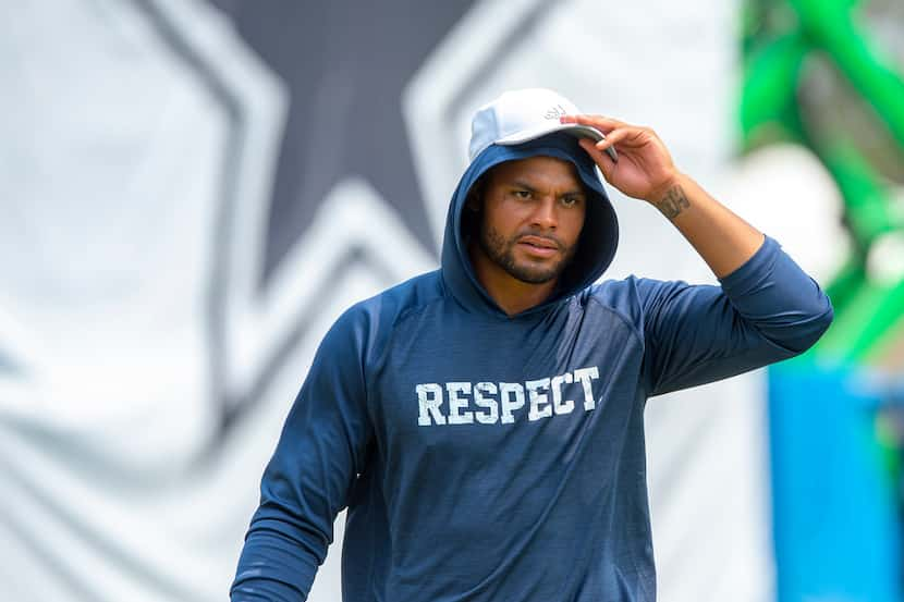 Dallas Cowboys quarterback Dak Prescott walks off the field after morning practice during...