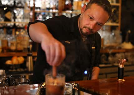 Jeremiah Franklin mixes a cocktail at Speak in Rockwall. The reservations-only restaurant...
