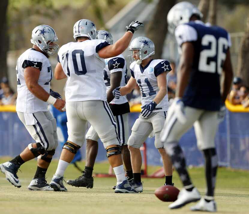 Dallas Cowboys wide receiver Cole Beasley (11) is congratulated by his lineman Travis...