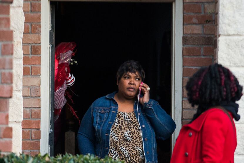 Jacqueline Craig talks on the phone as she leaves her house with attorney Jasmine Crockett...