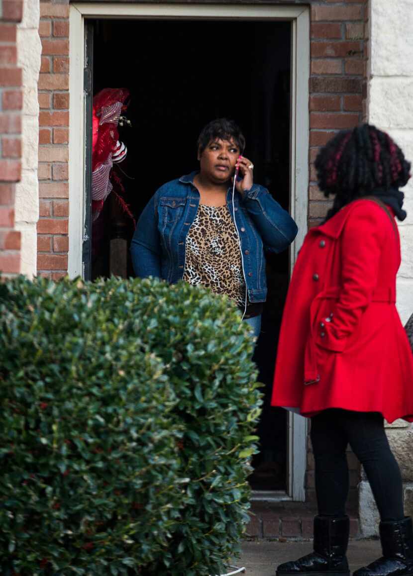 Jacqueline Craig talks on the phone as she leaves her house with attorney Jasmine Crockett...