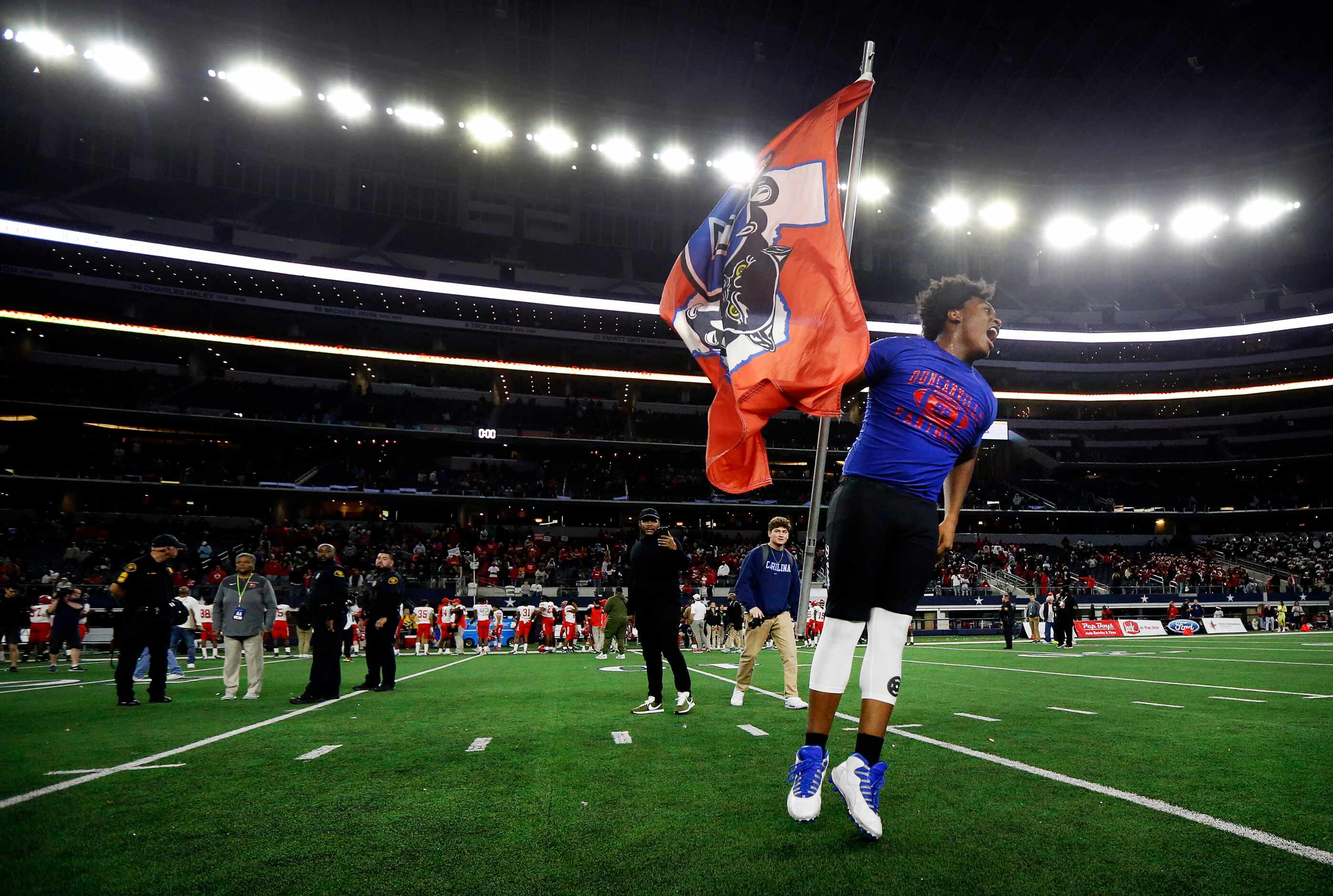 Duncanville defensive lineman Antwon Brown (99) planted the school flag on the field after...
