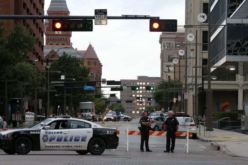 Dallas Police Department officers block Main Street near the El Centro College building in...