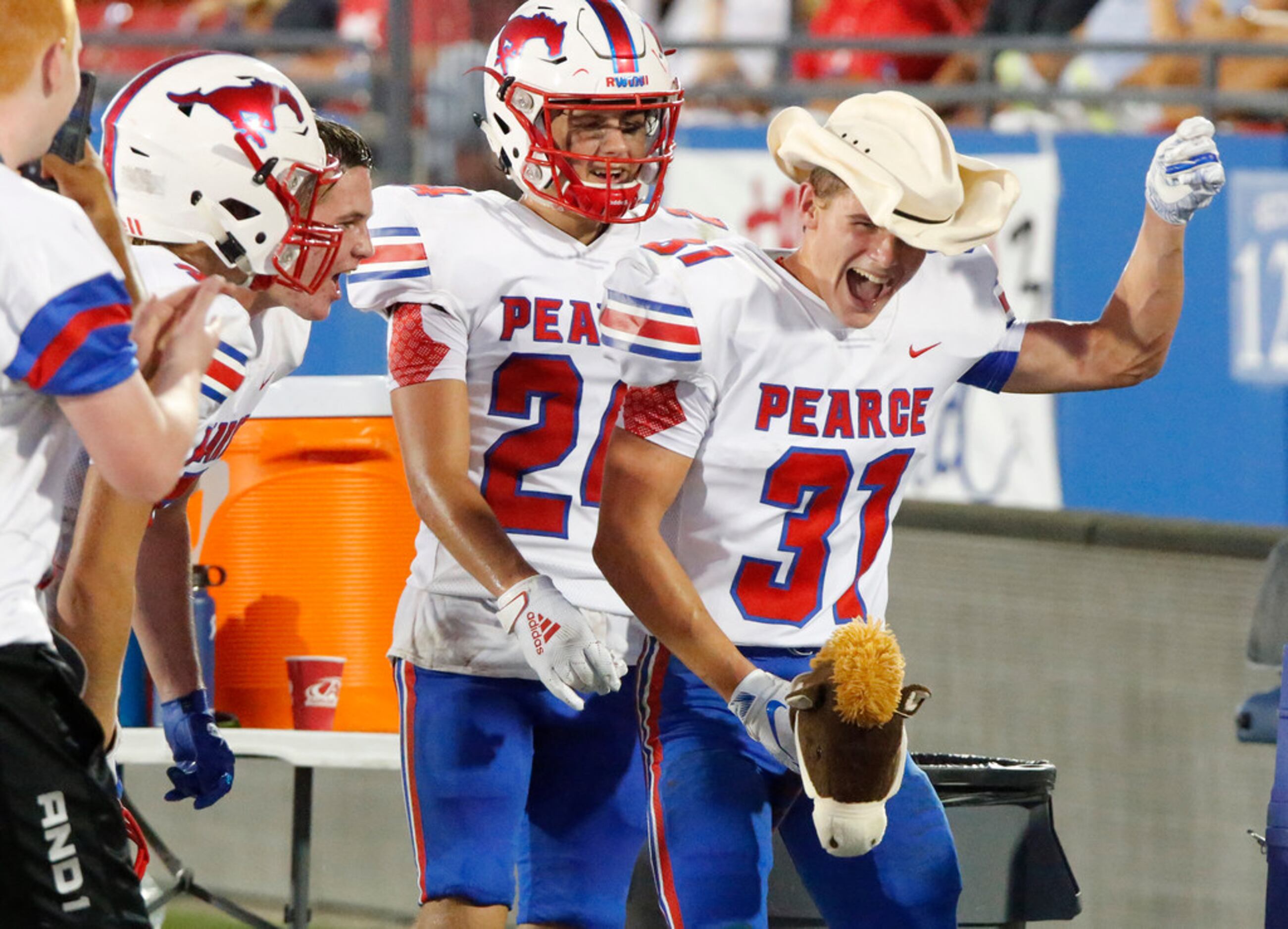 Richardson Pearce High School safety Trent Williams (31) celebrates on the sideline with a...